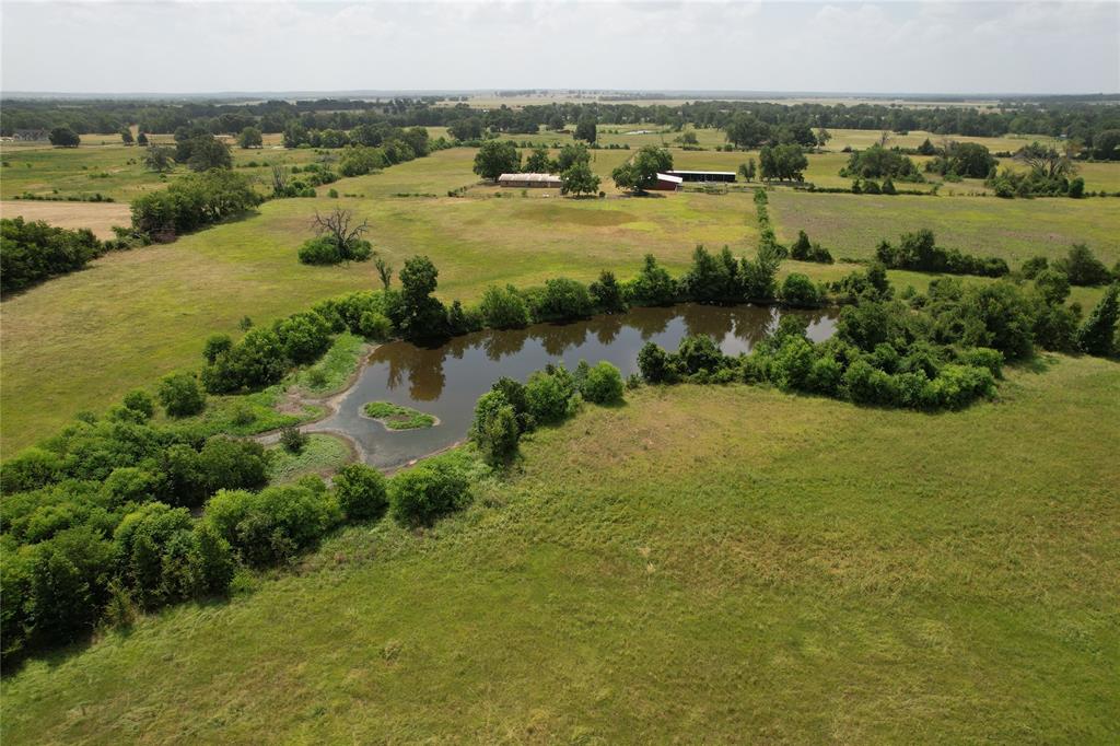 Come take a look at this beautiful property in the Porter Springs Community. This 3/2.5 home is located off of a low traffic Farm to Market Road and has a ton of desirable features that go along with this property. Upon entering, you’ll notice the nice fencing along the driveway, massive pecan trees that shade the yard, and two large red barns – both with electricity. One barn has been used to park equipment and the other has a shop, tack room, and a single horse stall that adjoins the well-built metal cattle pens. At the rear of the house is a cyclone fenced backyard and a water well for livestock. The surrounding pastures have been for bailing Coastal hay and large pond is located on the property for livestock. Inside the home, you’ll notice the ample counterspace in the kitchen and cathedral ceilings in the living room. The primary bedroom has his and her closets and tub/shower combo. This home also has a two-car garage that is accessible from the utility room. Call today!