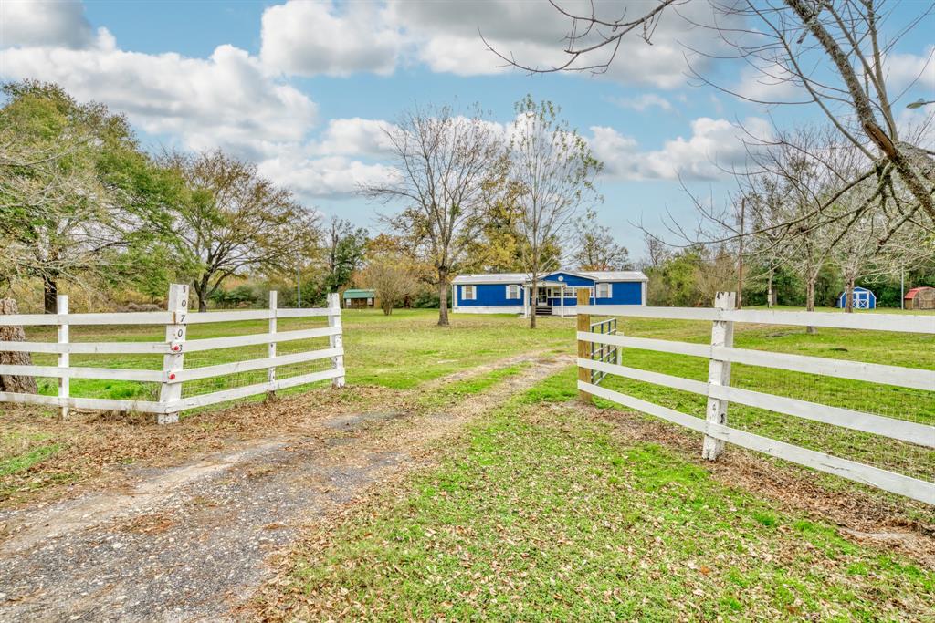 Experience the serenity of rural Texas living with this expansive 9.33-acre tract situated on the NE side of Madison County with 2 sides of Road Frontage.  Showcasing 2 nice Mobile Homes, this property presents a perfect opportunity for the buyer who needs 2 primary residences or one primary residence with a guest home or income producing rental.  MH #1 (Brown) was constructed in 2012, offering 2176 SF with 3 or 4 bedrooms and 2 full baths.  MH #2 (Blue) was constructed in 1999, has 1792 SF with 3 bedrooms and 2 full baths.  The beautiful, unrestricted property features a pond, 2 storage sheds, presents mostly open but has native trees around its perimeter, and Young's Creek meanders around the outer edge on the south side.  The two sides of road frontage promote easy access and create the potential for various development opportunities.  There is plenty of room for your animals, a garden, or outdoor entertainment.  Centrally located between BCS, Palestine, Houston and Dallas.