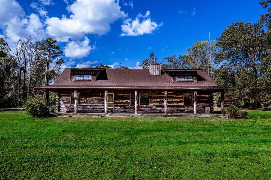 Prepare to be wowed by this meticulously hand-built & lovingly maintained all-natural wood log cabin, crafted by the original owner. Set on nearly an acre of land, this home offers an open-concept living space with stunning, all-natural wood flooring. The kitchen boasts hand-crafted cabinets with pull-out shelves, custom island & unique hand-crafted stairs. A split floor plan for privacy with 3 bdrms, 2 bthrms, plus a loft & extensive attic storage. The natural wood logs not only lend timeless beauty to the home but also help regulate temperature, keeping the house cool in the summer & warm in the winter. For those chillier days, a wood-burning stove provides additional warmth. Enjoy peaceful moments on either the front or back porches, where you can rock your cares away. The oversized 2 car garage, complete with a connecting workshop, offers plenty of room for all your hobbies. This is truly a one-of-a-kind home, combining craftsmanship, character, & functionality in perfect harmony.