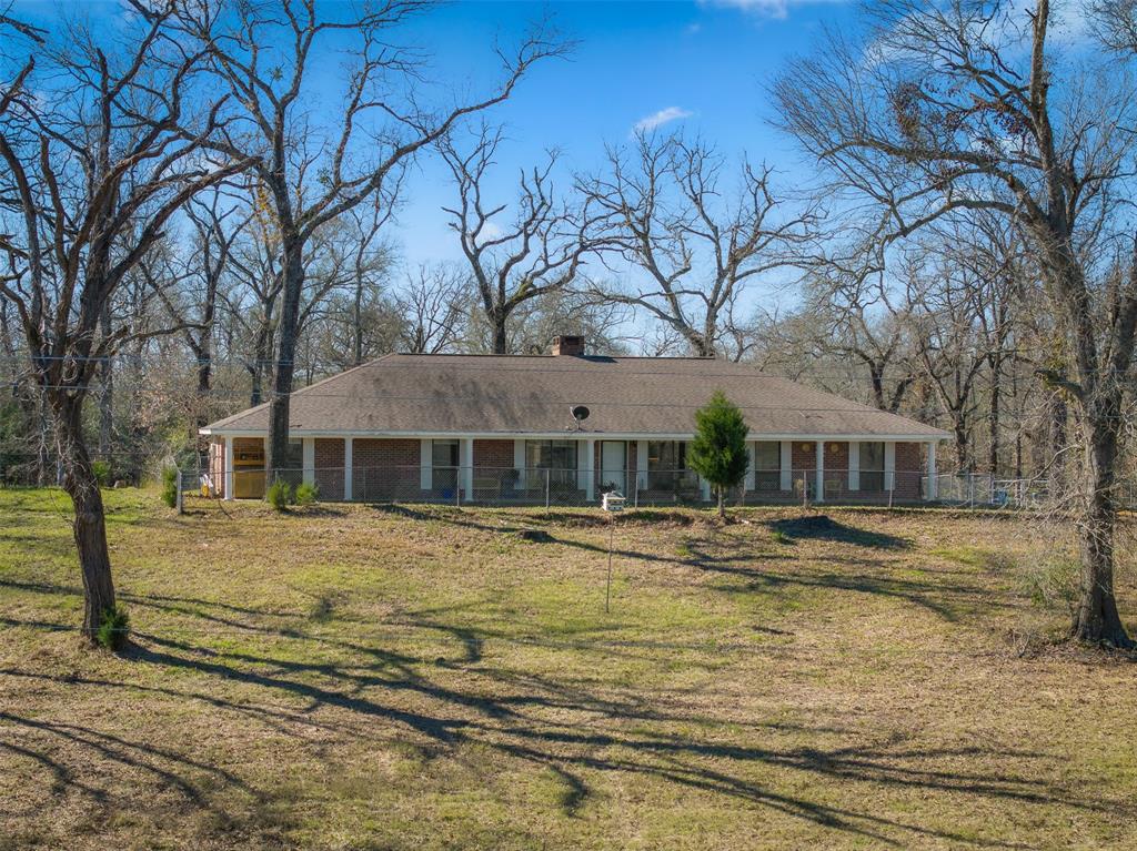 Nestled on 6.5 acres of scenic land, this beautiful brick home combines the tranquility of country living with the convenience of being just a short drive from Buffalo. The home’s high ceilings, large rooms & an abundance of natural light create a welcoming & airy atmosphere. You'll find a cozy wood-burning fireplace at the heart of the home, perfect for relaxing evenings. A spacious utility room doubles as an office, making it ideal for remote work. Outside, a covered back patio beckons for entertaining. With an attached 2-car garage & detached carport for extra parking, you'll have plenty of room for vehicles & storage. The fully fenced yard provides a haven, while the fenced pasture offers space for animals & gardening. A barn with a slab & pens is ready for your livestock, too. Mature trees dot the landscape, adding to the home’s peaceful charm. When you stop by, be sure wave hello to Boomer and Aggie, the mini donkeys keeping watch over the property. Don't miss out on this gem!