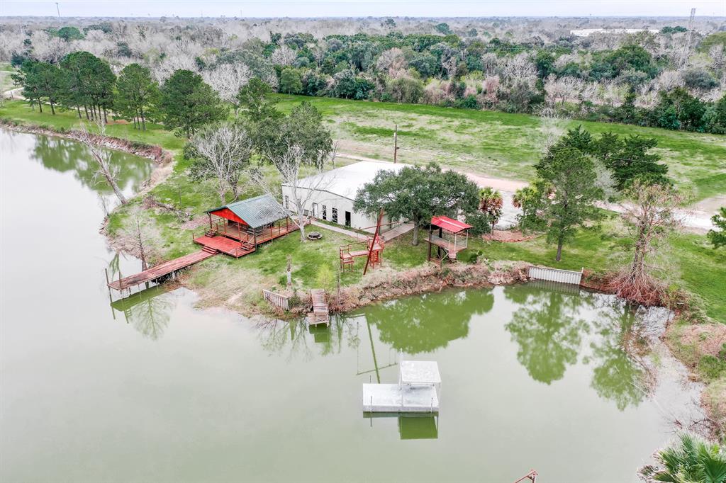 The possibilities are endless with this lot on over 29 acres in Alvin. Already through the first phase of converting to an RV Park, make this land your next business venture, or use the backdrop of the Texas skyline to build your dream home. Surrounded by large trees, the scenic acreage includes a private pond with deck and dock and clubhouse with stone exterior and covered front patio. Located off Highway 6 and Highway 35, the property features easy access to Pearland, William P. Hobby Airport, and Downtown Houston via Hwy 35. Nearby points of interest include downtown Alvin, The Center at Pearland Pkwy, and multiple nature parks.