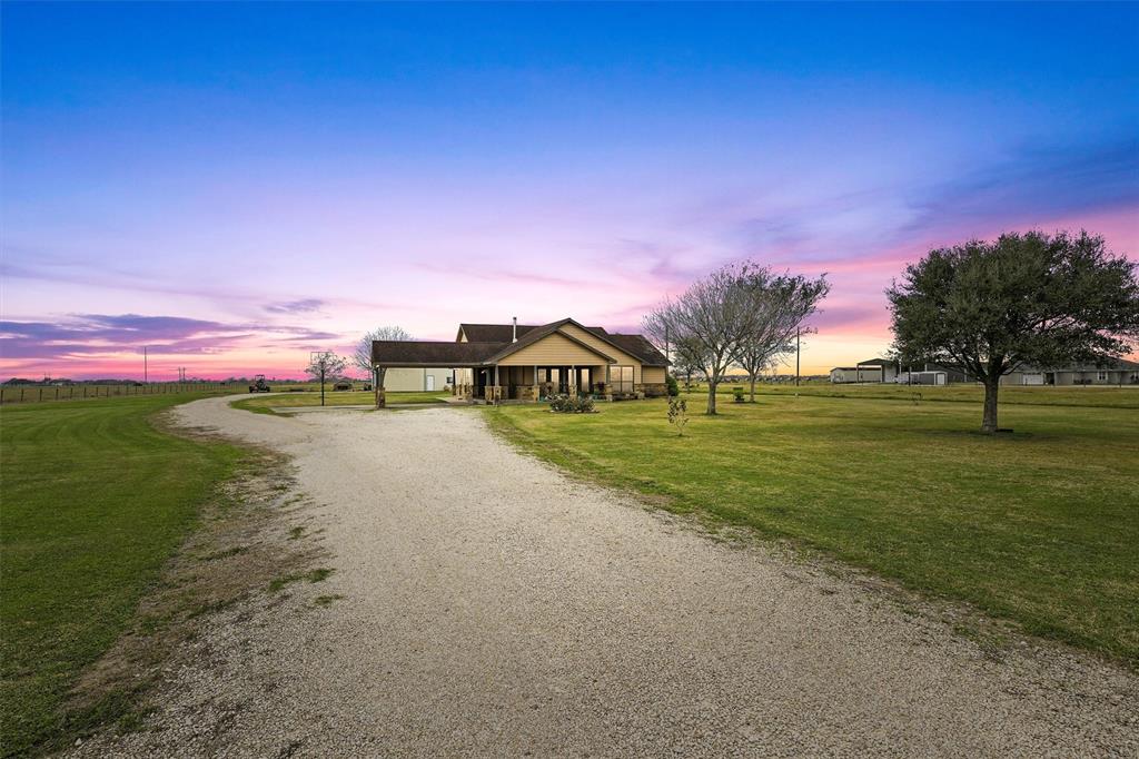 Welcome to the country and a serene escape! This quaint 3 bedroom, 2 bath home is situated on 10 acres of
native pastureland, fully fenced with electric gate entrance. Currently 8 of the 10 acres are
being used for hay production and listed as AG Exempt.  Conveniently located just 2 miles from I-69 and less than an hour commute to Sugarland or Victoria! The kitchen has granite countertops and stainless-steel appliances. Tile and wood flooring throughout home. No carpet!! Recessed lighting throughout, large closet spaces, extra-large laundry room area, and a wood burning stove for those extra cold winter nights! Property includes a 30x60 ft shop with 12x12 roll up doors, walk doors, cooking area, 6x12 climate-controlled
office/storage area, and 6x12 bathroom with shower. Water well/garden shed on slab, 12x12 ft dirt floor shed that is fenced for animals, with producing fruit trees and garden! You'll love those quiet evenings under either covered patio watching the sun rise or set.