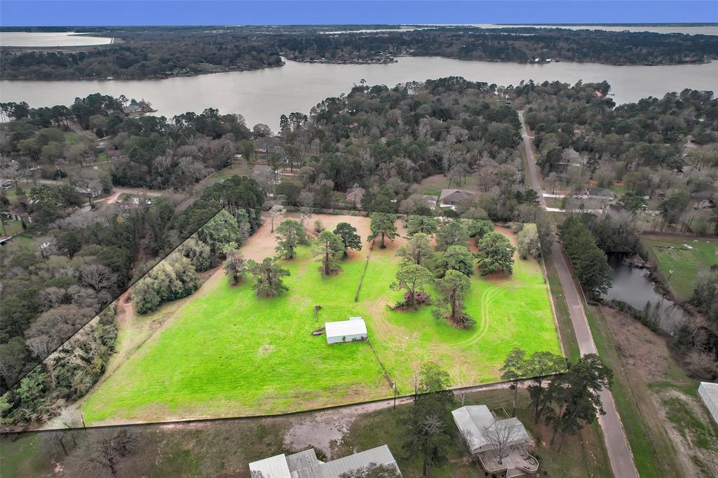 Located in the quickly developing area of Willis, TX, just moments from Lake Conroe, this 8+ acre property with a 30x50 pole barn offers a wealth of potential. The land is fully fenced, cleared and is already equipped with a well and electricity is on-site. The property has approximately 455' of road frontage on Paradise Point and also backs to Paradise Lane. With no restrictions, this versatile property is perfect for a variety of uses, including a tiny home community, RV park, storage facility or design your dream home and pool! Can be subdivided! Whether you’re looking to develop or build your private retreat, this property provides the space and infrastructure to bring your vision to life. With close proximity to the lake and in an area seeing rapid growth, the possibilities are endless.