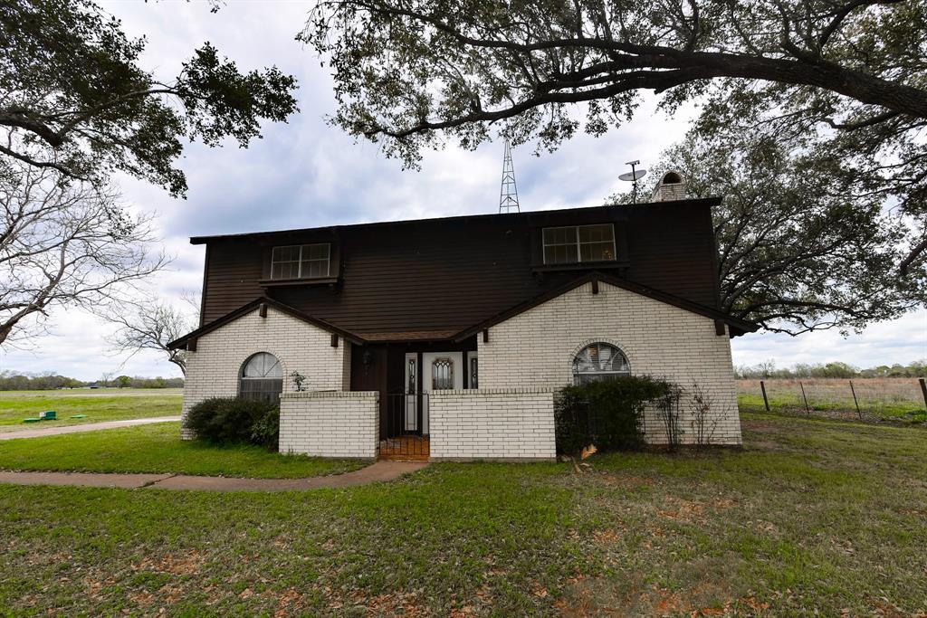 Welcome home to this stunning 1973 home full of character! Located south of Sealy, in the small community of Frydek, Texas this house is nestled underneath 50 year old live oak and pecan trees in the countryside. This four bed two and a half bath home boasts 2,129 square feet, three garage spaces, a large living room, and two separate dining areas. Although the space is plentiful, the original woodworking details only add to the charm of the home with exposed beams and arched doorways throughout the downstairs. Updates such as a new HVAC system, septic system, exterior paint, and the roof are all recently replaced. Exteriorly, the home sits on 5.78 acres with opportunities for agriculture and homesteading. Don't wait to call this beautiful slice of heaven your own, call today!