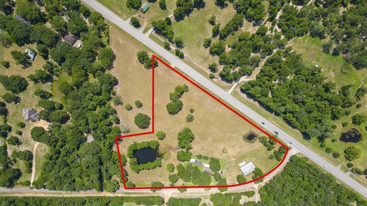 Discover an extraordinary opportunity with this stunning 6.25-acre property situated at the corner of Carrol Ln and FM 1097, offering over 1,000 feet of prime road frontage. This versatile property is cleared and brimming with potential for both commercial and residential use. The 1,452 sqft home features 3 beds, 2 baths. A separate guest house provides additional accommodations. For those with livestock or agricultural interests, the property includes a spacious 36x60-foot barn complete with exterior pig pens, wash rack for steers, and small pond. The property is fully fenced with an electric gate for added security and privacy, while the home is equipped with a reliable alarm system. Conveniently located with easy access to Lake Conroe and nearby amenities, this property is a rare find. Schedule your private tour today and explore the endless possibilities! *Additional adjoining 2 acres available!*