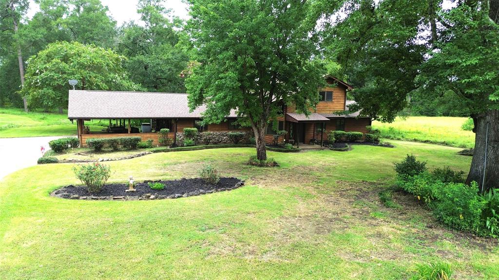 This beautiful 48.70-acre tract consists of a mix of open pasture, mature trees and pine plantation, and a pretty pond with a pier. A wooded creek also meanders through the back of the property. The home has an open floor plan with a large kitchen/dining area and a spacious living room. A floor to ceiling stone wood-burning fireplace is the focal point of this beautiful space. The primary bedroom has a walk-in closet and a bathroom with a jacuzzi tub and stand-alone shower. The main floor also has a ½ bath as well as bonus room that can be used as an office or additional bedroom. Upstairs, you will find two bedrooms with walk-in closets and a shared Jack and Jill bathroom. Outside, there is a double carport, storage, and half bath. The home has a deck with space for outdoor dining and a wraparound back porch looking out over the pond, giving views of gorgeous sunsets. Additionally, there is a green house and two barns. This is a must-see property! Call to schedule a showing.