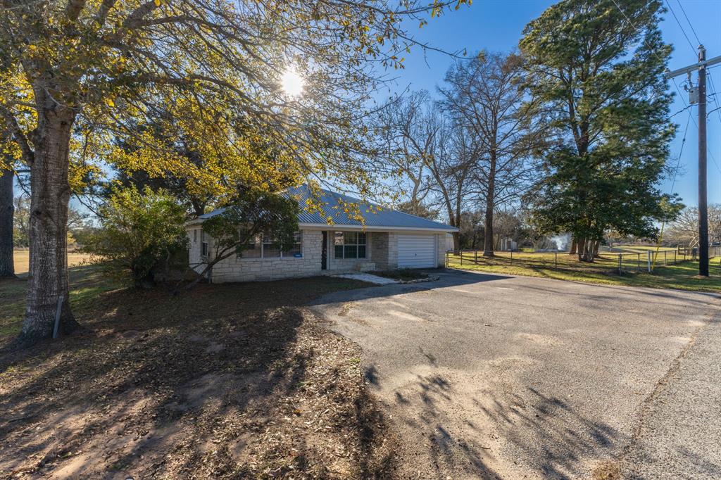 Your New Ulm Retreat on 7 Acres. Discover the charm of this 2 bedroom, 2-bathroom home, with the flexibility to create a third bedroom, all set on a sprawling 7-acre property in the heart of New Ulm with a large metal shop.

Less than 20 minutes to Columbus
Minutes from Industry, Bellville, and Cat Spring
Ample road frontage with the option to subdivide

Enjoy the peaceful country life while staying conveniently close to town. Whether you want to build, invest, or simply savor the serenity, this property is full of potential.

Comfort, space, and opportunity await!

Reach out today to schedule a tour or learn more!