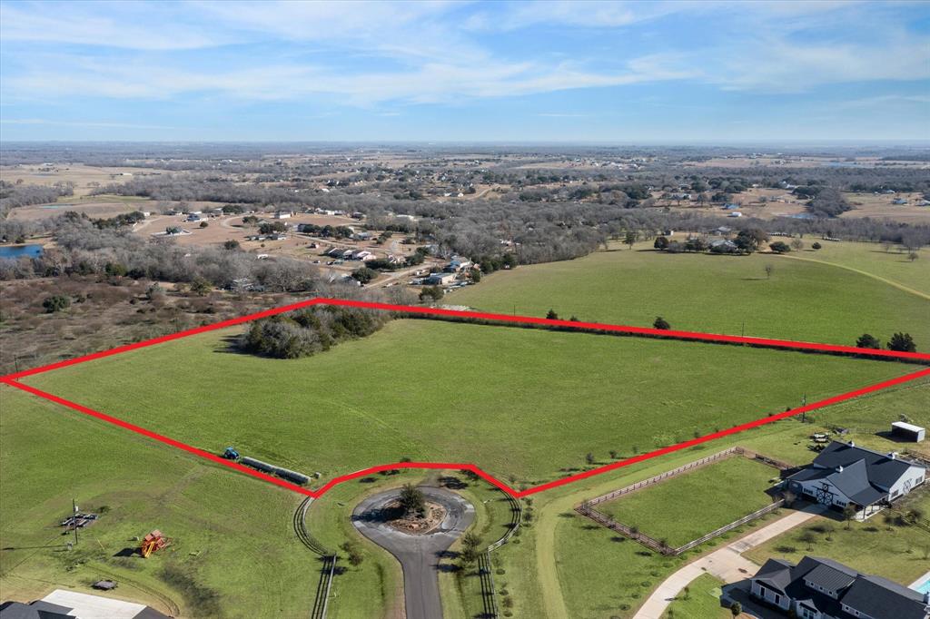 Discover this prime lot nestled between Chappell Hill and Brenham being 5 minutes to each. This lot is located within the exclusive Indian Trail gated subdivision, which boasts just 6 expansive ranchette lots, each approximately 10 acres. Picture-perfect board fencing and bluebonnets when in bloom, lines the road, complemented by community mailboxes and a meticulously landscaped entrance featuring gated access. This lot is high with elevations ranging from 310 to 330 feet offering unrivaled 360-degree vistas and positioned at the end of a cul-de-sac. Benefit from a low tax rate and an agricultural 1D1 valuation, significantly reducing property taxes. Surrounded by prestigious ranches and custom-built homes, Indian Trails ensures both community integrity and investment protection. As a gated community, showings are exclusively available through an agent. Don’t miss your chance—schedule your appointment today!