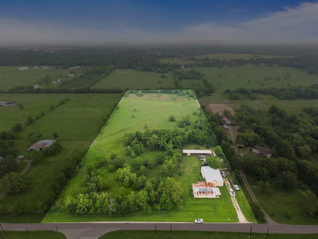 Situated just minutes from Downtown Houston and Pearland, this 10-acre AG Exempt Land in Manuel, TX is a rare find. The property boasts a converted workshop building with loft  and acres of lush greenery. Possibilties are endless with this versatile property. Recently home to horses, the land is ideal for those seeking unrestricted opportunities. The workshop building can accommodate up to 5+ vehicles plus equipment, making it perfect for a workshop or office. Workshop offers Shower/Bathroom, Storage, Kitchen and is made from Cinderblocks with Brick Veneer. This property is being offered "as is" Survey quote available. **Tenants removed horse stalls & gates when they moved out**Property also for Lease**Don't miss out on this unique opportunity - schedule a tour today!