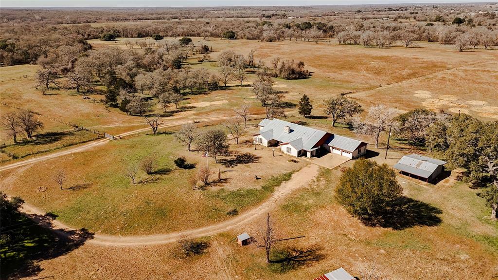 Nestled just outside of Bastrop, Texas, this expansive 112-acre cattle ranch offers the perfect blend of rural tranquility. The centerpiece of the property is a beautiful 3,345 sq ft ranch-style stone home, positioned atop a hill to provide breathtaking panoramic views of the surrounding land. Watch the sunset over your land from the back porch.

Fully equipped for your agricultural or recreational needs, with a large 50x30 equipment barn, a workshop, and a water well ensuring that you have everything you need to maintain your land and livestock. Property is fully fenced and cross-fenced.

Live water from Cedar Creek forms two boundary lines for the property while attracting local wildlife. Located near the end of a paved county road ensuring peace and privacy.

Located just an hour from Austin, Bastrop is quickly becoming a hub for tech and business, making this an ideal location. Don't miss the opportunity to own this incredible piece of Texas countryside.