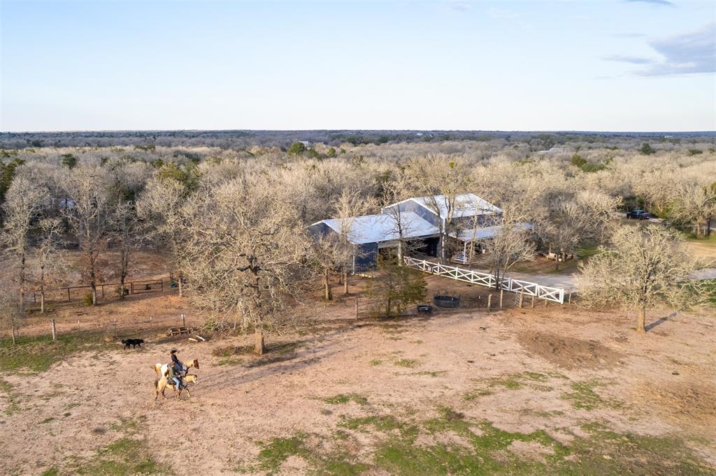 Welcome to Parada Ranch, a stunning 10-acre retreat with a 2021-built, 2,499 sq. ft. barndominium featuring 3 bedrooms, 3 baths, a flex loft, a modern kitchen, and a cozy fireplace. The property includes a 4-stall horse barn, round pen, rolling pastures, and serene woodlands, perfect for equestrian enthusiasts or outdoor lovers. Nestled at the end of a quiet road, it’s just 1 hour from Austin and 20 minutes from Bastrop. Complete with an EV charging station and ag-exemption via bees.