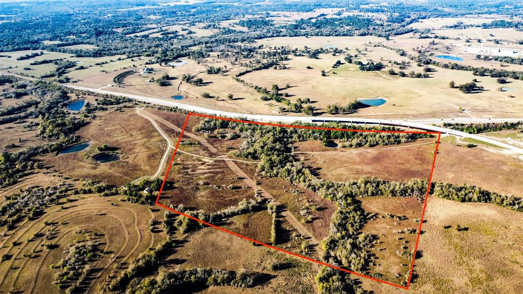 Explore the potential of this prime tract on Highway 105 and the 249-Aggie Expressway with dual highway frontage and adjacent to a freight railroad. Positioned in the direct path of development with beautiful terrain, this unrestricted property offers flexibility for various uses and developments. An great location for developers seeking visibility and logistic advantages.