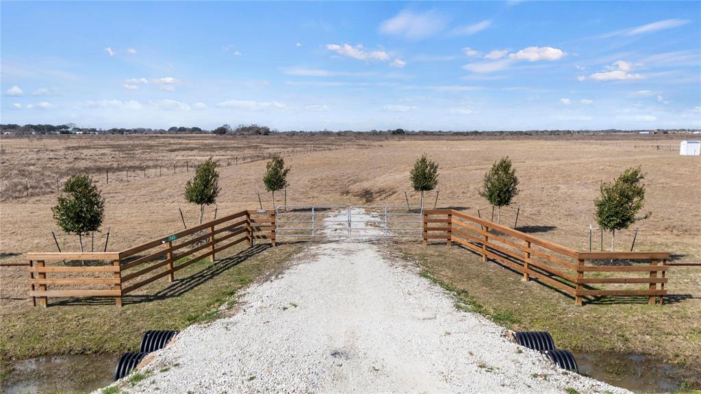 Property is grass.  Photos weee taken after the freeze so grass turned brown.This is your chance to own country acreage that delivers the peace and serenity of country living! This 5.49 +/- acre land tract has an exceptional location with easy access to Hwy 36 and the I-10 Corridor, yet just outside of the small town atmosphere of Wallis, Sealy, and a relative stones through from Bellville, Rosenberg, Katy, and Greater West Houston. The property comes improved with new construction five-wire barbed perimeter fencing that is anchored by an impressive equestrian style 4 Rail entry drive fencing, a water well, 15 newly planted trees with irrigation system and electricity in place other attractive features. If you're looking for a beautiful spread in the country with easy access to where you want to be, the land you are looking for may have just found you! The land is lightly restricted to preserve the beauty and enjoyment of your Texas country homestead for years to come.