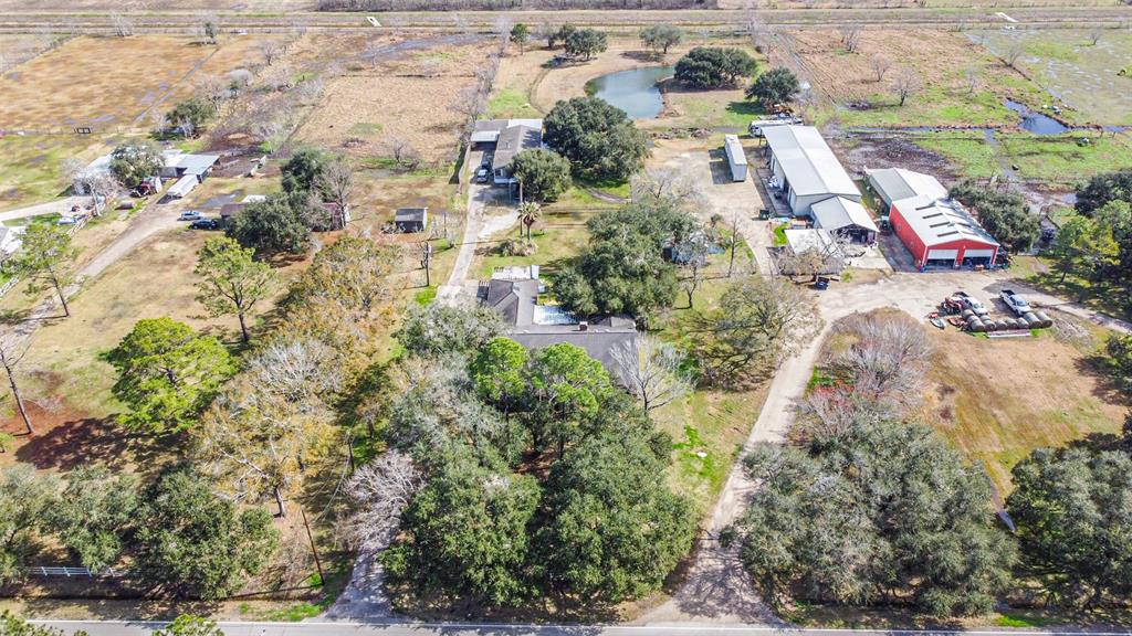 You belong Here! Situated among this property's sprawling 213,183 sq ft. (4.7+ acers) is a catfish stocked pond; a leased 2,432 sq ft. 4bed/3bath manufactured home with 2 car garage; an income producing workshop wired for 220 with 5,200 sq ft. under roof including a bathroom and office; an additional 1bed/1bath auxiliary dwelling unit with 800 sq ft.; as well as a generous 3,443 Sq Ft., 4bed/3.5 bathroom primary residence with a detached 3 car garage. All this versatility and utility conveniently located in Top Rated Pearland ISD, with no HOA, and minutes away from shopping and entertainment. Additional pictures coming! Thank you for your consideration. Let us and these country roads take you HOME! Schedule your showing today!