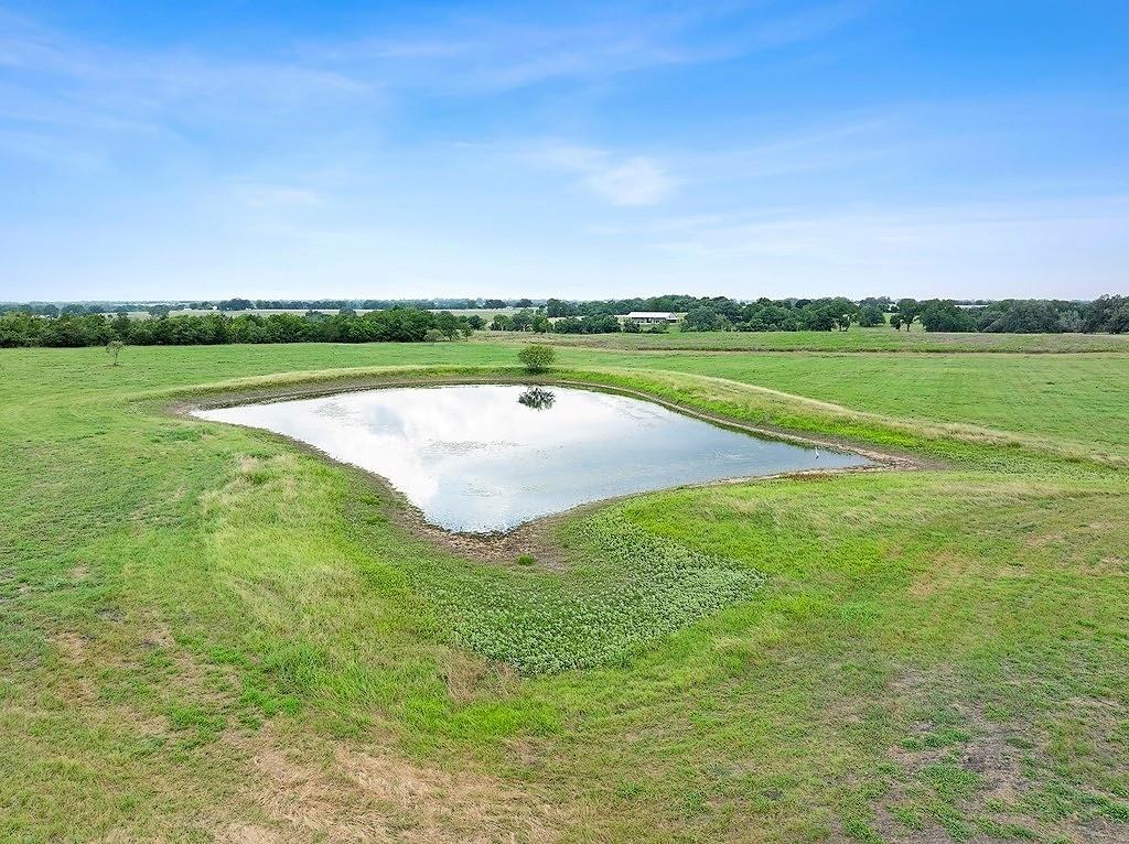 Nestled in the heart of Colorado County, just 10min south of Weimar's I-10 Exit 682 and an hour west of Katy, this 32 acre property offers a blend of residential, recreational, and agricultural potential. The gently rolling terrain and improved pastureland provide an ideal homesite overlooking a pond, with expansive views of the countryside. Ideal for those seeking a peaceful retreat or a working farm, the property boasts paved road, predominantly clay soil, and an elevation of 320'-340'. Notably, there is no floodplain, making it both safe and accessible. It enjoys an ag exemption and is home to native wildlife, offering opportunities for outdoor enjoyment. With larger neighboring properties, this land offers both privacy and ample space. The seller is open to dividing the property into two parcels: one +/-18 acres with pond, and another +/-14 acres. Mineral rights are negotiable. Contact us today to explore this exceptional property and seize the opportunity to make it your own!