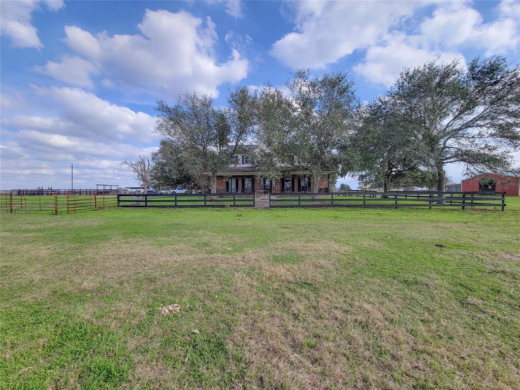 This charming country home, custom-built by Heartland Homes in 2002, sits on 10 acres of land, fish filled pond and a 34x48ft horse barn with a tackroom;good for your horses or FFA animals. The main floor features a spacious dining area connected to a country kitchen with an island and granite countertops, as well as wood-look tile floors throughout the entire first floor, French doors lead to a study or formal dining room, while the family room boasts a lovely fireplace. The primary bedroom downstairs includes an updated bathroom with double vanity countertops and a large walk-in slate tile shower and soaking tub. Upstairs, there are 4 additional bedrooms w/one large bd can be gameroom and 2 bathrooms. Laminate stairs and upstairs, no carpet. Let's rodeo in the  riding pen and covered stage, all conveniently located with easy access to Sealy, Houston, San Antonio, and Austin. Additionally, the property includes septic, well, and propane, with low taxes.