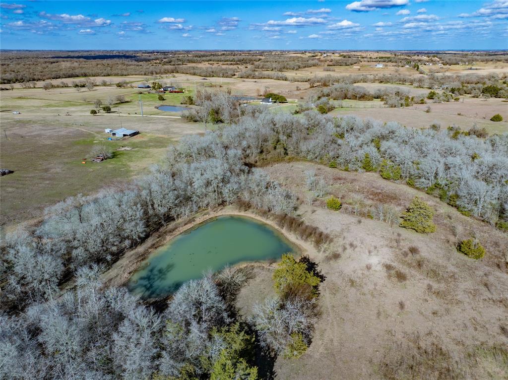 This special 29+ acre property offers an exceptional opportunity for anyone seeking a versatile piece of land with city conveniences and breathtaking natural beauty. Located in the charming town of Industry, TX the property boasts direct frontage on SH 159 and includes access to essential city services, including water, electricity, and wastewater connections. The land features a harmonious blend of open pastures(60%)and mature wooded areas(40%)creating an ideal setting for agricultural use, residential development, or recreational enjoyment. The rolling terrain provides spectacular views to the north and northeast, perfect for a dream home site or peaceful retreat. A picturesque pond enhances the property, offering a serene spot for fishing and a reliable water source for livestock. With abundant possibilities, this versatile land is well-suited for ranching, investment, or a custom build that captures the essence of country living. Don't miss this one!