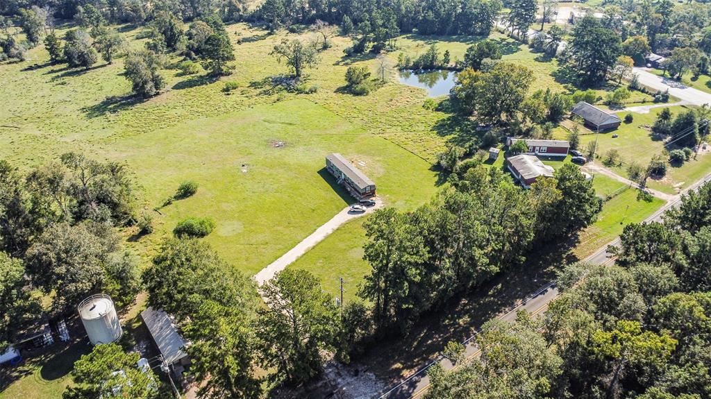 Prime location at the intersection of FM 2693 & Hwy 150 between New Waverly & Coldspring!!!  Gorgeous pasture land with a stocked fishing pond!  Unrestricted with super low taxes!  Cattle lease currently in place that allows for Agriculture exemption.