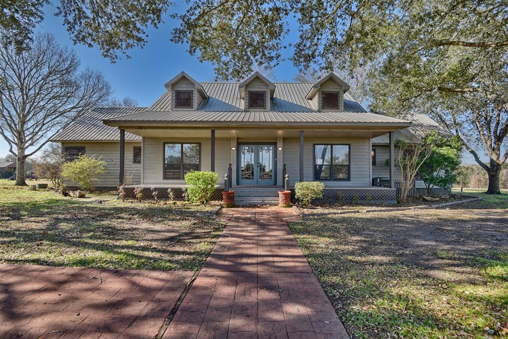 LET'S GO TO THE FARM! Sheppard Creek Ranch offers 42.2 acres of rolling hills, scattered Live Oak and Pecan trees, a lot of deer, a 2845 sf Main House, 1195 sf Guest House, Covered RV parking and a large barn/shop. The property has been a cattle ranch with hay production and borders both Ganske Creek and Sheppard Creek creating a great habitat for wildlife. The improvements are set back over a hill and out of sight from Hwy 290. The custom, main home was built with high end finishes. Enjoy panoramic views from the living, dining, kitchen and Primary bedroom which stretch across the back of the house, shaded by a back porch. There is a huge kitchen and butler's pantry and all wood floors on the 1st floor. Upstairs are 2 huge bedrooms. The guest house has 2 bedrooms & 2 baths, a front porch and covered parking. The 40'x32' shop/barn is great for trailers and farm toys. The RV parking has electric & septic.