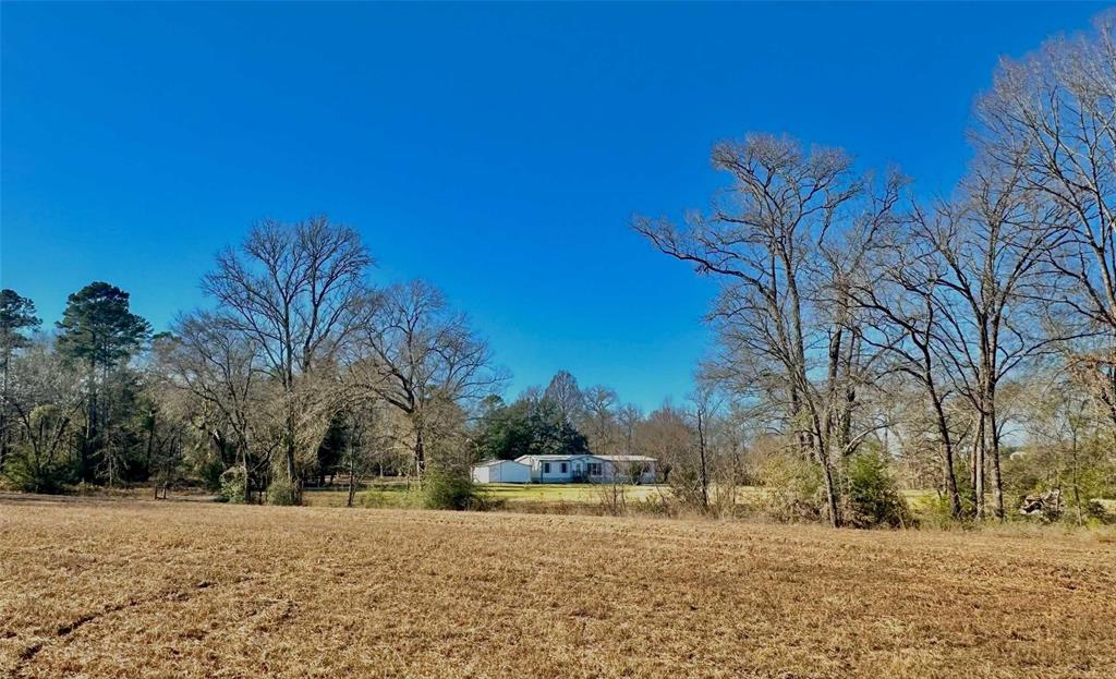 Live your ranch or hunting cabin dreams on this 33-acre tract in the heart of Elkhart, prime East Texas pasture and white tail deer land!  Perfect for homesteaders and hunters alike, this property offers 2 acres of crop rows disced and tilled and ready for hearty vegetables and Texas fruits.  A small grazing pasture with an old barn is great for smaller herds or as a hay pasture. The rest of the property is filled with mature lush timber, teeming with wildlife, and a network of trails for hunting or ATV rides. A charming and cozy farmhouse with 3 bedrooms and 2 baths has over 1800 sq feet of space.  A workshop with two large bays can house all your equipment, recreational toys, or be transformed into an excellent working office.   This almost fully self-sustainable property is a rare find!  With an option to purchase additional acreage with a stocked pond, the possibilities here are endless.  Seize your opportunity for ranch and hunting land in beautiful East Texas—call today!