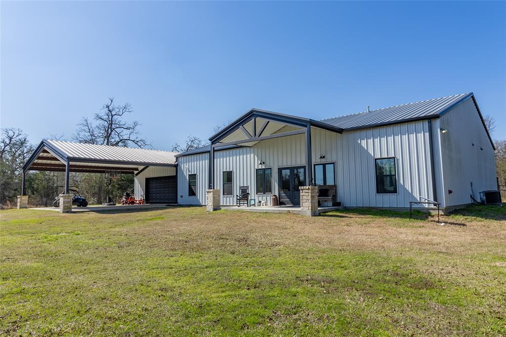 Newly built Barndo on 13 acres of peaceful nature right off HWY 90. This 2,108sf home has all the amenities one would want or need. The spacious living area provides comfort while the large granite island offers space for entertaining. Kitchen is equipped with a gas stove top, double ovens, farm sink with a touch faucet, custom built cabinets and appliance garage. The 3 bedrooms have their own private bathroom with a walk-in closet. Primary suite includes dual sinks, soaking tub and large, tiled shower including a rain shower head. Laundry and mud room lead to the large garage equipped with additional access to the back porch that is plumbed for gas.  Nature lovers will enjoy the fenced acreage along with the stocked pond. For guests, there is a 30' RV shed with water, electric and second septic. Wildlife exemption in place. Anderson ISD. Don't miss out on this chance to own a beautiful property in Grimes County.