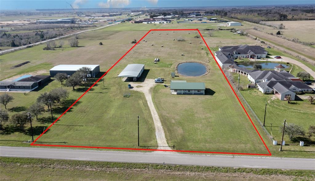 Don't miss this fantastic opportunity in growing Needville! Situated on 10 acres, this 1,800 square foot ADA compliant home boasts a spacious living/dining/kitchen area. Enjoy a shaded front porch, a custom rear grand porch facing a serene pond, water well, and aerobic septic system. The property features a 3,200 square foot foam insulated barn with two AC units, bathroom, and office. Multiple entrances and a covered area offer versatility for residential or commercial use. With 2 bedrooms, 2 bathrooms, and endless possibilities, this property is a must-see!