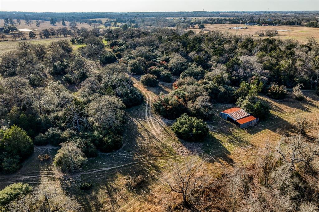 This stunning property is being offered for sale for the first time in decades. There is a variety of tree types; post oaks, live oaks, cedars, etc. The property has good fencing on all sides and is currently used for cattle. There is an approximate 60 foot differential in elevation. This is a wildlife paradise. Deer, hogs, turkey and ducks have all been spotted recently on the property. If you are looking for a place to escape the city, this is it. The views from the highest elevation are really incredible! There is a set of cattle pens and a barn for storage. Aqua water at road and Bluebonnet electric on site.