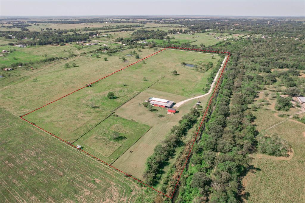 Charming Country Retreat Nestled amidst serene surroundings, this beautiful 4 bedroom, 3.5 bath home is the perfect blend of rustic charm and modern fixtures and finishes. The spacious owner's suite has a private bath and an ample walk-in closet suite. With easy access to Hwy 124 and Interstate 10, a short drive to Beaumont or Houston makes 1213 Big Hill an ideal escape from city life. Experience the heart of nature as this property spans 28.55 acres of lush, scenic land and a pond stocked bass and perch fish. Limitless opportunities for entertaining, outdoor activities and escape from the Texas heat in the above ground pool. Enjoy panoramic views, mornings on the front porch or cozy evenings by the fireplace. Lots of natural light, open concept living, 2 Kitchens and 1 boast as a gourmet kitchen with high end stainless appliances and granite countertops. The outbuilding can serve as storage, hobby space or an Income generating property. Schedule your private tour today!