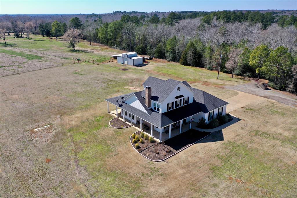 Escape to the county and experience the charm of this beautiful farmhouse style home built by Harris Building Company set on 40+ acres. With 3 bedrooms and 2.5 baths, the home features a generous layout with plenty of room for family living. The cozy living areas are filled with charm, featuring large windows to let in plenty of natural light, shiplap walls, woodburning fireplace and a warm, inviting atmosphere. The open concept kitchen is the heart of the home offering ample counter space, premium appliances (dual fuel range), a charming farmhouse style sink, beautiful wood accents and a large island for family meals or entertaining. Step outside to experience the views & abundant outdoor space - perfect for farming, livestock or simply enjoying nature. The property also includes a barn and small pond. Dreaming of a home with character and charm, this is it! cats do NOT go out!