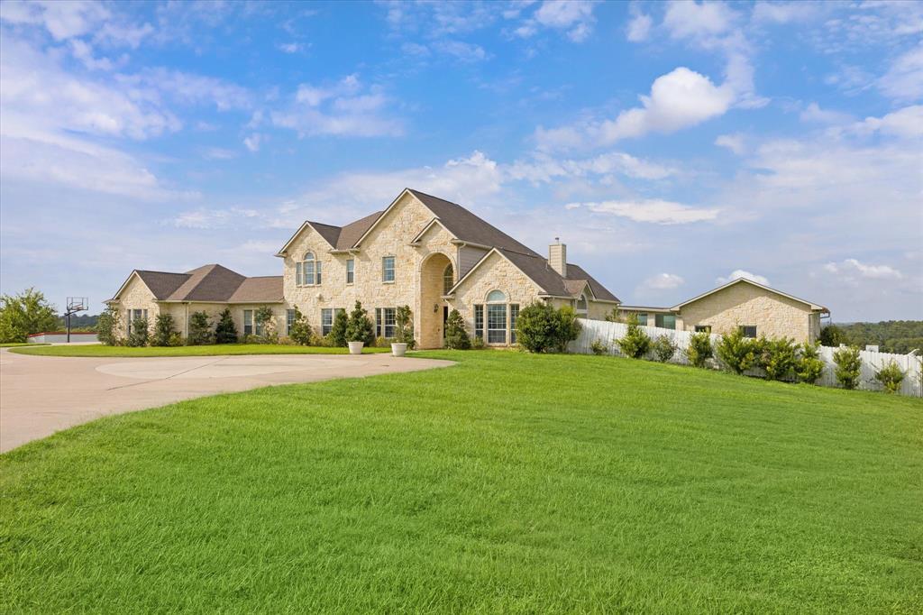 Refined 430-acre ranch atop the rolling hills of Austin County. The observable elevation of the property provides panoramic views of Texas landscapes' natural beauty. The land is coated with native grasses as well as vast
wooded areas for the abundant wildlife. Other features include multiple ponds, 5 water wells, barns and the Mill Creek. At the heart of the property, you will find the 8,000 sq. ft. home with 6 bedrooms and 6.5 baths.  The open concept floor plan flows from the kitchen to the living with a wet bar and through the French doors that open to the covered outdoor kitchen. A hallway leads you to a private winged main bedroom, bath and office. Improvements include pool, spa, large outdoor kitchen/seating area, 3 car attached garage, detached 4 bay garage, and entertainment facility that would serve purpose to many uses. All amenities of the home are easily reached by connected sidewalks. A Historical home also sits on the property that is perfect for a ranch hand or guests.