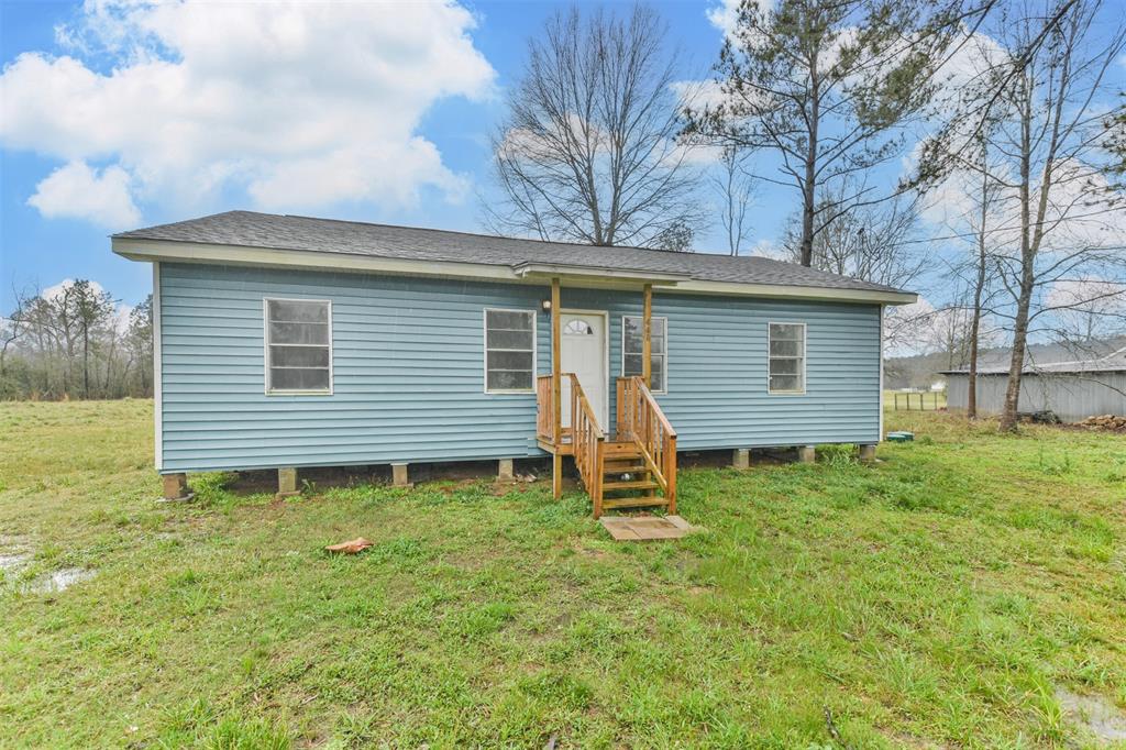 Nestled on a spacious lot, this inviting 2-bed, 2-bath home offers a peaceful retreat with plenty of room to grow. The exterior features fresh blue siding, a durable roof, and a welcoming front porch with wooden steps leading to the entrance—perfect for enjoying the serene country surroundings. Step inside to an open-concept layout, where abundant natural light pours in through large windows, creating a bright and airy atmosphere. Designed for both practicality and charm, the updated kitchen has high-end features. This property offers a rare opportunity to embrace wide-open spaces, fresh air, and the freedom to create your own homestead, hobby farm, or private retreat. With mature trees providing shade and character, along with ample open land, this setting is ideal for nature lovers, privacy seekers, and outdoor enthusiasts. Whether you dream of gardening, raising animals, or simply enjoying the peace and quiet, this home provides the perfect backdrop for country living at its finest!