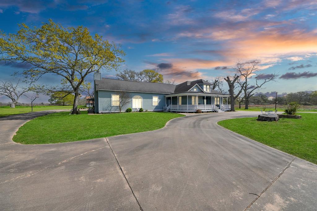 Charming 4,400+ sqft Victorian-style home sits on nearly 10 acres w/ ag exemption, offering plenty of space w/ beautiful pecan trees surrounding the property. A welcoming wraparound porch invites you in, leading to a home that offers 3 bed & 3.5 bath w/ a cozy wooden/gas fireplace in the large living room & a full wet bar, perfect for entertaining. Upstairs, a versatile bedroom/game room includes its own bathroom, shower, & 2 walk-in closets. The primary suite feels like a private retreat, offering patio access & an indoor sitting area. A spacious office/study provides a quiet space for work or relaxation. Outside, you'll find a high-fenced area for pet safety, & plenty of parking w/ a half-moon driveway in front. The property also features a 2,400 sqft barn & rear access to the acreage, adding even more opportunities. W/ custom wooden cabinets & ample storage throughout, this home is filled w/ so many charming details that no amount of words will do it justice. It’s truly a MUST SEE!