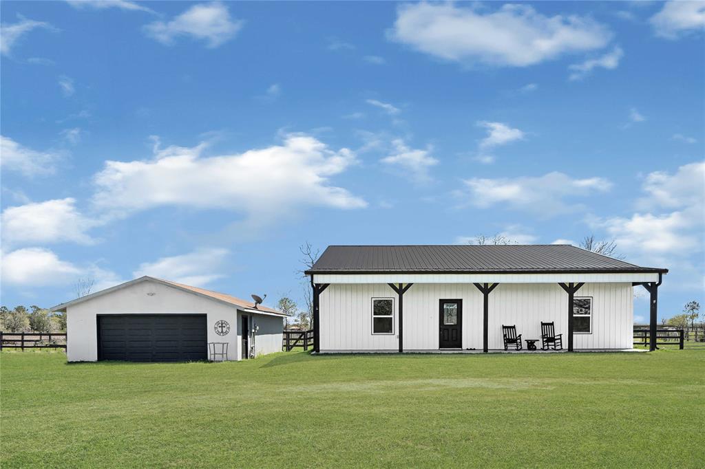 Wide open spaces..... This recently built barndo has all of the open space you could want. It's open floor plan has lots of natural light and it is great for entertaining. This home is light and bright with beautiful finishes throughout. There is lots of storage and the floorplan was definitely well thought out.  There are almost 3 acres of fenced land, a functional chicken coop, a shelter for the animals and the property has extra fencing so that you are able to separate some of the animals if needed. The large, covered patio in the back has plumbing ran to it.  There is a large closet in the hallway that locks, this room would be great for the avid hunter to lock up their equipment and keep it safe. Fiber optic internet is being installed in the area through "Ezee Fiber". There is a 2-car detached garage, and a storage shed. Close enough to the city for shopping and eating, but far enough away for some peace. This home has never flooded and does not require flood ins. at the moment.