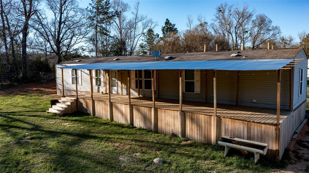 This charming 2-bedroom, 2-bathroom single wide home is nestled on 10.27 acres of fenced and cross-fenced land in a prime location. The property features multiple loafing sheds, a 6-stall barn with a pipe wash-rack, a separate large workshop building, and a lovely pond. Close to Cleveland and within the Coldspring ISD, this home offers easy access to Double Lakes and is just a short 20-minute drive to Lake Livingston. Built in 2018, this Country Farm & Ranch property at 101 Tyler boasts 1152 square feet of living space on a spacious 10.27 acre lot.