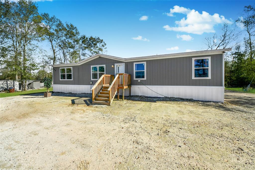 This 2024-built manufactured home offers 4 bedrooms and 2 bathrooms within 1,475 square feet of living space. Situated on a 2.56-acre lot, the property features a front driveway reinforced with added gravel, accommodating heavy-loaded trucks. The interior boasts modern finishes, including a well-appointed kitchen with contemporary appliances. The open-concept design connects the living, dining, and kitchen areas, creating a spacious and inviting atmosphere. The primary bedroom includes an en-suite bathroom with a double vanity and a walk-in shower. Additional bedrooms are well-sized, suitable for family members or guests. The exterior boasts durable construction with energy-efficient windows and a new roof. Located in Cleveland, TX, this property combines modern amenities with the tranquility of a generous lot size.