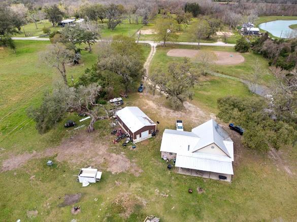 Over 35 unrestricted acres with AG exemption at the end of a dead-end road! Fully fenced with an automatic gated entrance. The home was completely remodeled in 2021, with the exterior featuring a metal roof. Inside you will find an open concept kitchen, dining, & living room with the primary suite & 2 more bedrooms on the main level. The kitchen has gorgeous granite countertops, stainless-steel appliances, & a pantry. The stone wood-burning fireplace leading up to the vaulted ceilings is the focal points of the living room. Upstairs is a guest suite complete a full bathroom. The home is insulated with spray foam & blown-in insulation. Enjoy your free time under the huge covered concrete patio overlooking this peaceful land, which is cross-fenced to allow for easy care of multiple animals. The barn was added in 2019 & has electric & plumbing. Situated in Columbia-Brazoria ISD, only about 7 miles from the Chevron Phillips plant, 30 miles from Lake Jackson, & 44 miles from Rosenberg.