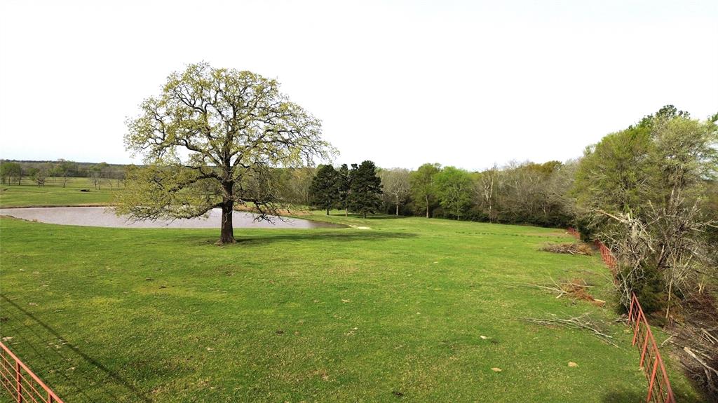 Check out this beautiful 27+ acre property that would make an amazing homesite, with great views from the porches of your future home! Located only three miles from Lovelady, this site has access from a quiet farm to market road, and pretty pipe fencing along the highway frontage. The high elevation at the front of property overlooks a large stock tank that holds over a million gallons of water and has a water well along the east side, if it’s new owner would like to included with the sale. Beyond the stocked tank, the vast pastureland drops down to a well-built bridge that navigates over the creek bisecting the property, where you’ll see the scattered large oak trees throughout. Its owner reports an abundance of grass that sustains a high yield of cattle and lots of wildlife that likes to come out to forage. So, if you’ve been considering purchasing a property to build your forever home in the Lovelady School District, then give us a call today!  **Additional acreage negotiable**