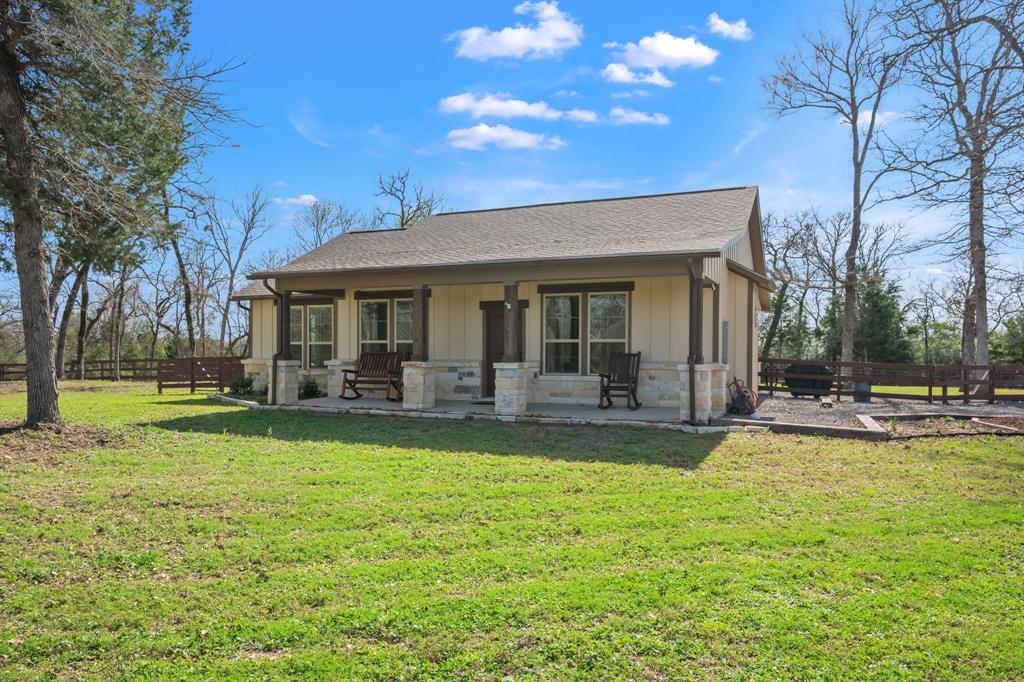 Check out this beautiful, better-than-new home on 5 wooded acres in Timbercrest, complete with a fenced yard. There's no need to wait for new construction—this dream home is ready for you! Enjoy the outdoors from the covered front and back patios, or relax by the fire pit. Inside, you'll find a spacious living area with raised ceilings and wood beam accents, open to a kitchen featuring a large island and stainless steel appliances. The stone fireplace with hearth adds a cozy touch to the space. The home also boasts a walk-in pantry, tile in all high-traffic and wet areas, and granite countertops throughout. The primary bedroom includes a large vanity and an expansive walk-in tile shower. Plus, the rolling wooded acreage behind the house is perfect for exploring.  Save on taxes with the wild life AG exemption already in place.  Call for your private tour.