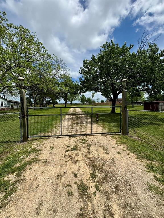 Whether you're ready to build or settle in with your RV this property is perfect. Nearly a 4 acre tract available with city water and sewer, along with a private water well. This Property is fully fenced, cross-fenced, lush Bermuda grass covers the pasture. Also has a sturdy pole barn that includes a feed room. Large 24 X 30 shop features: 1 sliding door, 2 additional doors, enclosed air conditioned room, hot & cold running water, utility sink, stove, hot water heater, attic area and 50 amp plugs. Carport equipped with 30 & 50 amp electrical service, concrete floor and porch area. Separate utilities available for both lots. Survey and elevation certificates on hand. New privacy fencing along the carport area for added seclusion