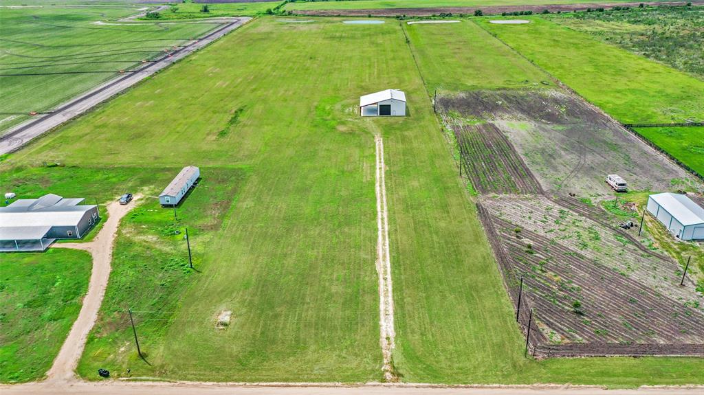 1797 County Road 328 Louise, Texas Looking for a sprawling 10 acre ag exempt property with pond? This property is fully cleared and ready for your vision. This versatile tract features a 40x60 metal building with a 25x60 lean-to, offering plenty of space for storage, projects, or future expansion. The barn is equipped with three roll-up doors two being 16x16 ft, one being 10x10 ft. LED lighting is throughout the entire barn and under the lean-to as well. Another great thing about this property is that it is rough-plumbed, making it easy for conversion into a barndominium or ideal as a workshop. The property also includes two full RV hookups, all utilities in place, electrical, water well, and aerobic septic system. Whether you're building your dream home or looking for a weekend escape, this land offers flexibility and functionality in a peaceful rural setting.