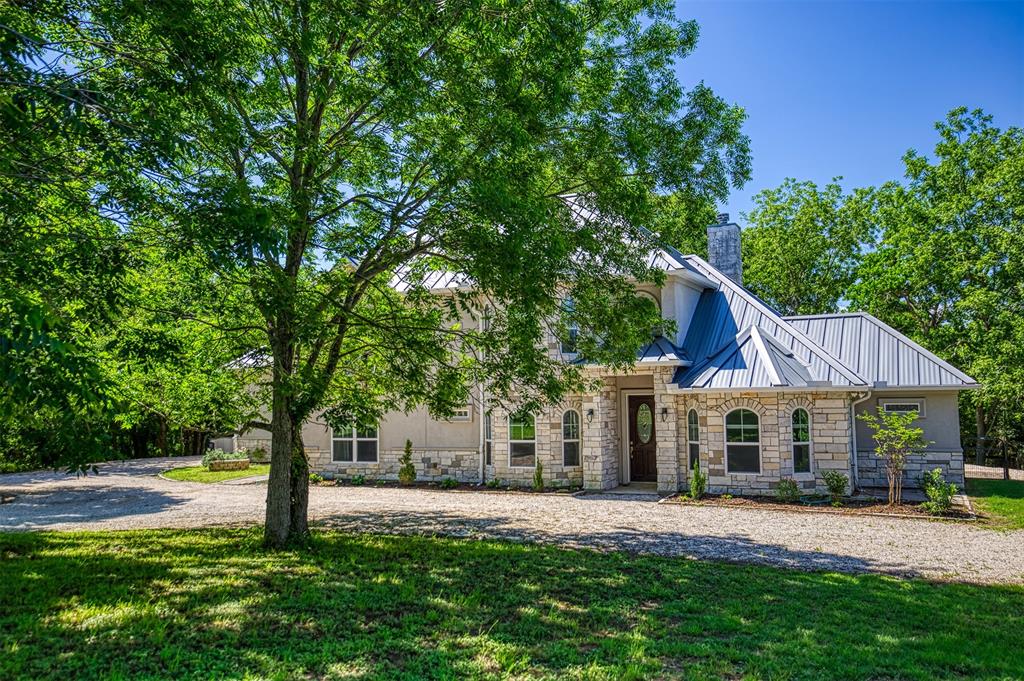 3560 Wm B Travis Lane Brenham, Texas This rustic property offers two homes on ±10.88 acres and blends privacy with charm and modern features. The main 2-story home offers ±3,667sq.ft., 4 beds, 3 baths, open layout, spacious living, kitchen, breakfast area, formal dining & study. Downstairs has 2 beds & 2 baths; upstairs includes living area/kitchenette, 2 beds, a full bath, and bonus room. The home also features Energy-efficient Insulated Concrete Shell construction, a two car attached garage, a metal roof, solar tubes, and solar power (carport-integrated). The second home is ±1,398sq.ft. with 3 bedrooms, 2 baths, rustic cabin style, exposed beams, front porch & rear wooden patio. The property offers native pasture, woods, wet-weather creek, 30'x40' metal shop, and sits at the end of a quiet road. A country setting just 4.5 mi to Brenham, 40 mi to College Station & 60 mi to Houston. Rural living with nearby amenities. A full feature list available. Don’t miss this rare chance to own a beautiful multi-home property!