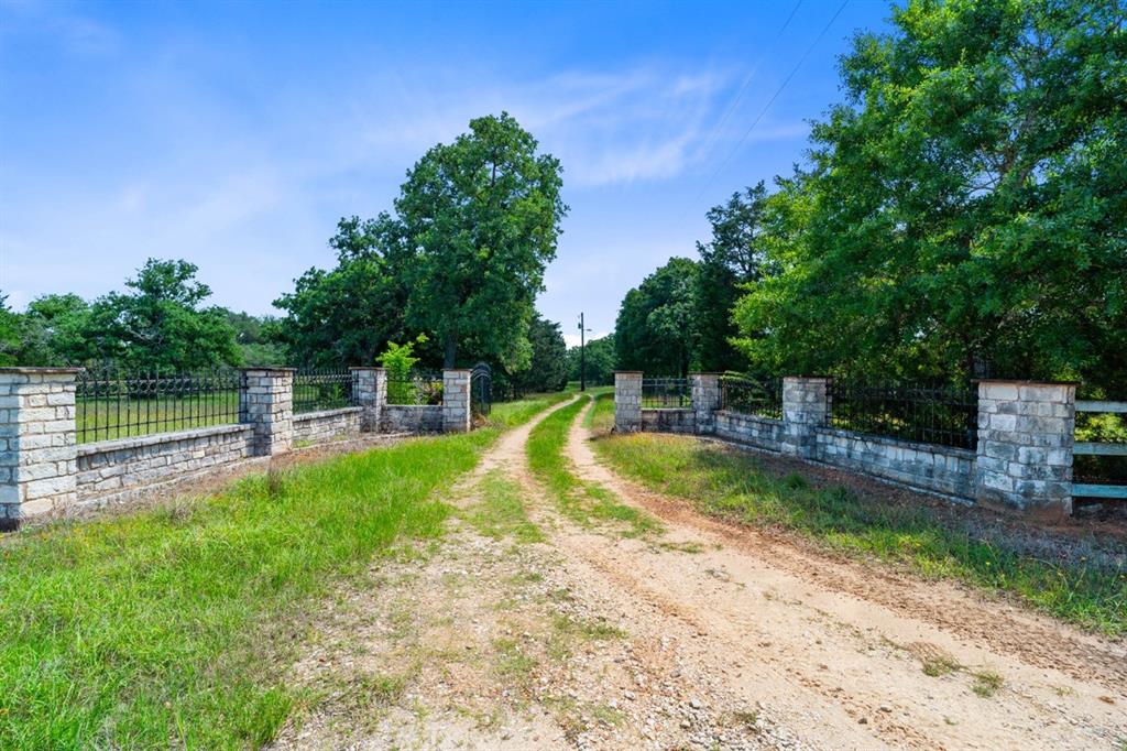 1019 Deerfield Court Weimar, Texas This stunning ranchette located in The Oakridge Ranch Subdivision is conveniently situated with easy access to major cities like Sugarland, Houston and San Antonio via I-10 and US-90. Immerse yourself in a peaceful setting that offers both privacy and tranquility. This property spans 46 wooded acres featuring 2 serene ponds, 3 water wells, and a spacious cleared area ideal for new construction.
The charming 2 story home includes 1 bedroom + loft, 2 baths, a modern kitchen, updated downstairs bath, recently replaced a/c units and roof completed in 2022. This home is truly move in ready for the new owner.
Adjacent to the home, you'll find a 20X58 barn with 5 bays. A concrete slab is also laid down for potential new construction, complete with architectural house plans that will be conveyed to the new owner. The property is wildlife exempt and teems with deer, hogs, turkeys, & small game. It borders 2 roads and features 4 entry gates ensuring convenience and accessibility.