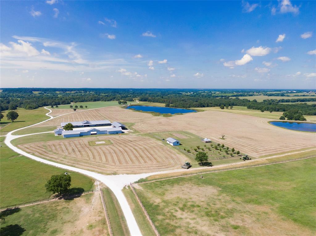 000 Tract #1 Whitehall Ranch Road Navasota, Texas Tract one of Whitehall Ranch Estates consists of 127.75 acres. Featuring rolling pastures of coastal Bermuda grass, mature native pecan and oak trees, and the year-round Beason Creek forming its western boundary. The land offers privacy with scenic topography and tree-lined views from the road. This stunning tract is cross-fenced with central working pens and well-placed access points. Horse pastures are secured with 2”x4” non-climb wire and slick top wire; cattle pastures are fenced with four-point, five (5) strand American barbed wire. A 3.5-acre seasonal wetland attracts native wildlife, supports livestock, and draws migratory waterfowl annually. It is anchored by a 28,000-sq-ft stabilized yard, which includes a workshop, equipment barns, and 20-stall stables featuring two efficiency apartments, an office, two tack rooms, and feed storage. Amenities include a helipad, greenhouse, chicken coop, garden, and a fenced orchard, which has its natural beauty and versatile improvements.
