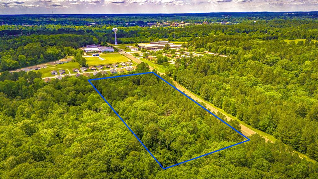 4.97 Acres – Prime Location with Road Frontage Near Nacogdoches!    Discover the perfect blend of country charm and city convenience on this 4.97-acre parcel, offering plenty of road frontage and partially cleared land—ready for your dream home or investment project.    Located just:  3 minutes to Walmart  5 minutes to Nacogdoches Memorial Hospital  4 minutes to Stephen F. Austin State University    Enjoy the peace and privacy of country living while staying just minutes from the heart of Nacogdoches. With utilities nearby and easy access to major roads, this property offers a rare opportunity to build your ideal lifestyle without compromising convenience.  Don't miss out—acreage like this in such a prime location doesn't last long!    The boundary lines on the photos are provided for visual reference only and should not be relied upon for legal or surveying purposes.