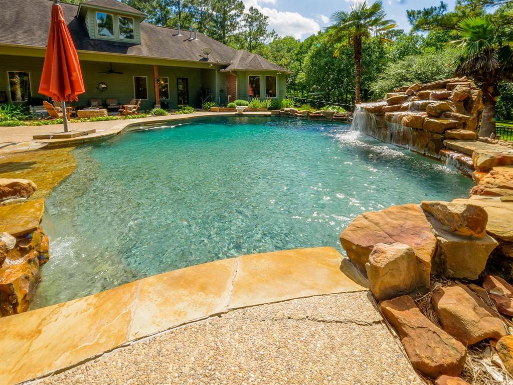 Tranquil Country Estate on 31 Acres

Experience the perfect blend of luxury and nature with this 4,035 sq ft custom home on 31 picturesque acres in Montgomery, TX. Step through the grand entry into a spacious foyer that sets the tone for this elegant residence. The well-designed floor plan includes a luxurious master suite with a private seating area and direct patio access, creating a serene retreat.

Outdoor living shines with a heated pool featuring a beach entry and cascading waterfall—perfect for relaxation and entertaining. The covered porch pergola offers a shaded haven for outdoor dining.

Nature lovers will enjoy the spring-fed pond, attracting local wildlife, and the versatile barn. A wildlife tax exemption provides notable savings while supporting land stewardship.

Located in Montgomery ISD, this estate offers upscale living and country tranquility. This exceptional property offers a harmonious blend of comfort, functionality, and natural elegance.