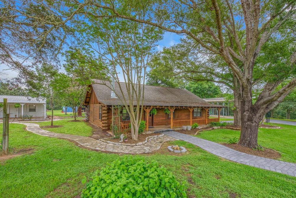 Welcome to your private retreat on 17.6+/- beautiful acres, offering a perfect blend of open spaces and mature woods. This unique property includes two residences and is accommodating  for those seeking space, serenity, and flexibility. The main home is a rustic and comfortable log cabin that exudes warmth and charm, featuring natural wood accents, cozy living areas, a gorgeous updated kitchen area, and picturesque views of the surrounding landscape. The 1/1 "cottage" is fitting for extended family and friends, an Airbnb, or overflow for weekend gatherings.  Additional highlights include a 18x30 RV station with concrete slab, electricity, water, and connected to septic and a 12x24 storage building.  Whether you're looking for a peaceful homestead, a hunting property, or a weekend getaway, this versatile property just 25 minutes to Kyle Field has endless potential.
Schedule your private showing today!