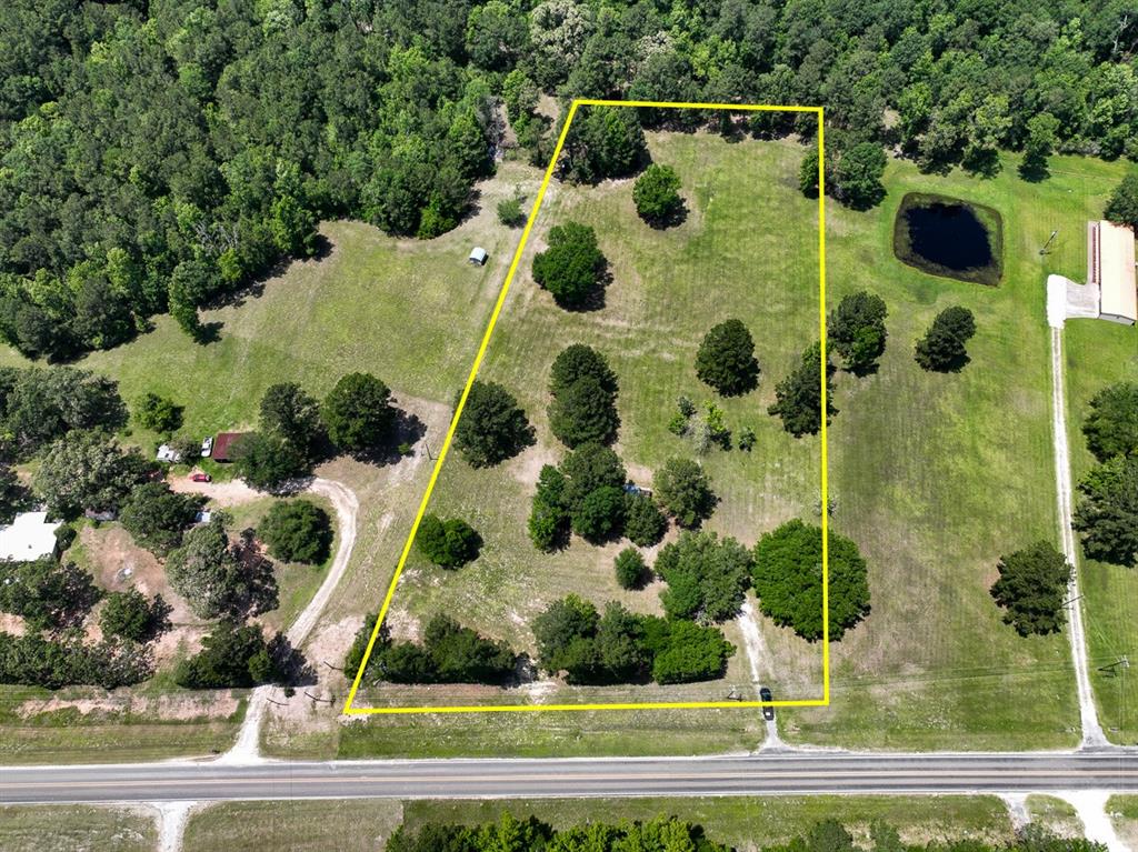 The Old Homestead ! Ready for the next generation. Beautiful acreage and setting with mature live oaks, pines, and various other tree species. Generally, site ready for new home construction. Driveway in place. Electricity and water (subject to availability) along FM 355. Well maintained neighbors and area. Low traffic FM road. Equipment shed. Fenced along back property line. Near Lake Livingston access.
