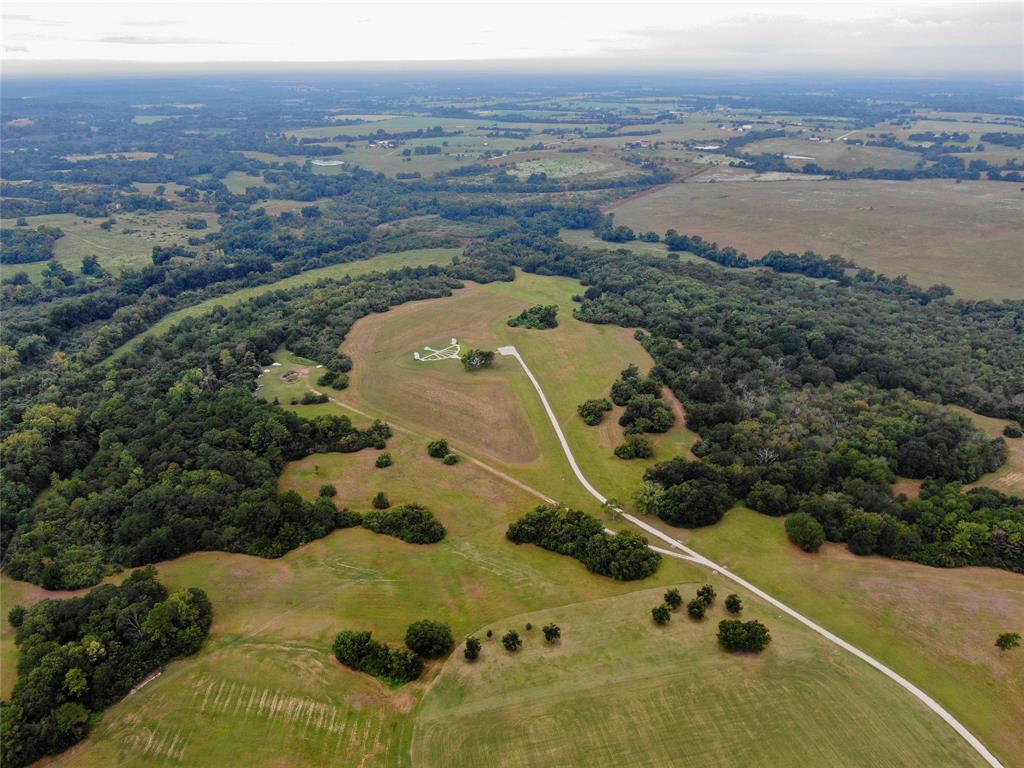 Tract 4 of Whitehall Ranch Estates, consisting of 89.88 acres, offers privacy, views, and exceptional recreation. A scenic pond sits on a gentle hillside surrounded by mature trees. Along a ridge lies an 18-acre seasonal wildlife food plot and a top-tier skeet/trap range with Italian-manufactured throwers, wireless controls, concrete paths, benches, and gun racks. An air-conditioned cabin with a kitchen, restroom, and TV makes it perfect for hosting. Rolling terrain, spring-fed creeks, and shaded trails offer multiple homesite options. The thriving whitetail deer population and natural beauty make Tract 4 ideal for relaxation and outdoor activity in this premier deed-restricted ranch community.