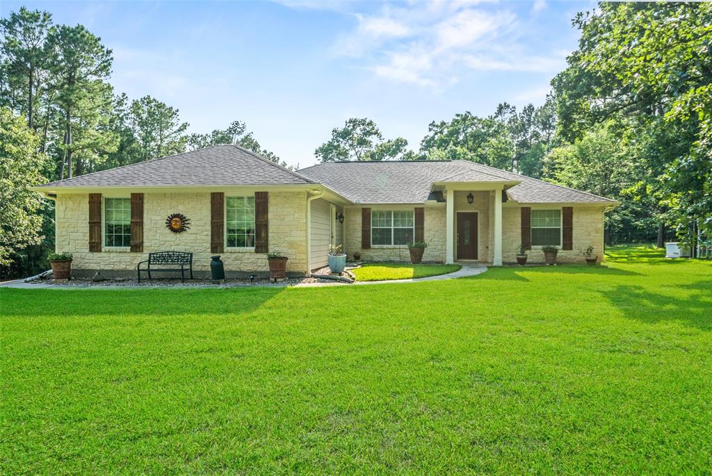 9025 Amelia Drive Anderson, Texas Escape to the tranquil beauty of this stunning 10.13-acre property in Timber Hills. A gated entrance leads to a 3/2 home with granite countertops, spacious island kitchen, stainless steel appliances, and walk-in pantry. Relax in front of the rock gas fireplace or entertain in the open floor plan with formal dining. The primary bedroom boasts double sinks, tiled shower, and walk-in closet. Step outside to a large patio with fireplace and grill. Additional features include a whole-home generator, aerobic system, and a 50x30 shop with heat and bathroom. Enjoy low taxes, maintenance, and abundant of wildlife.