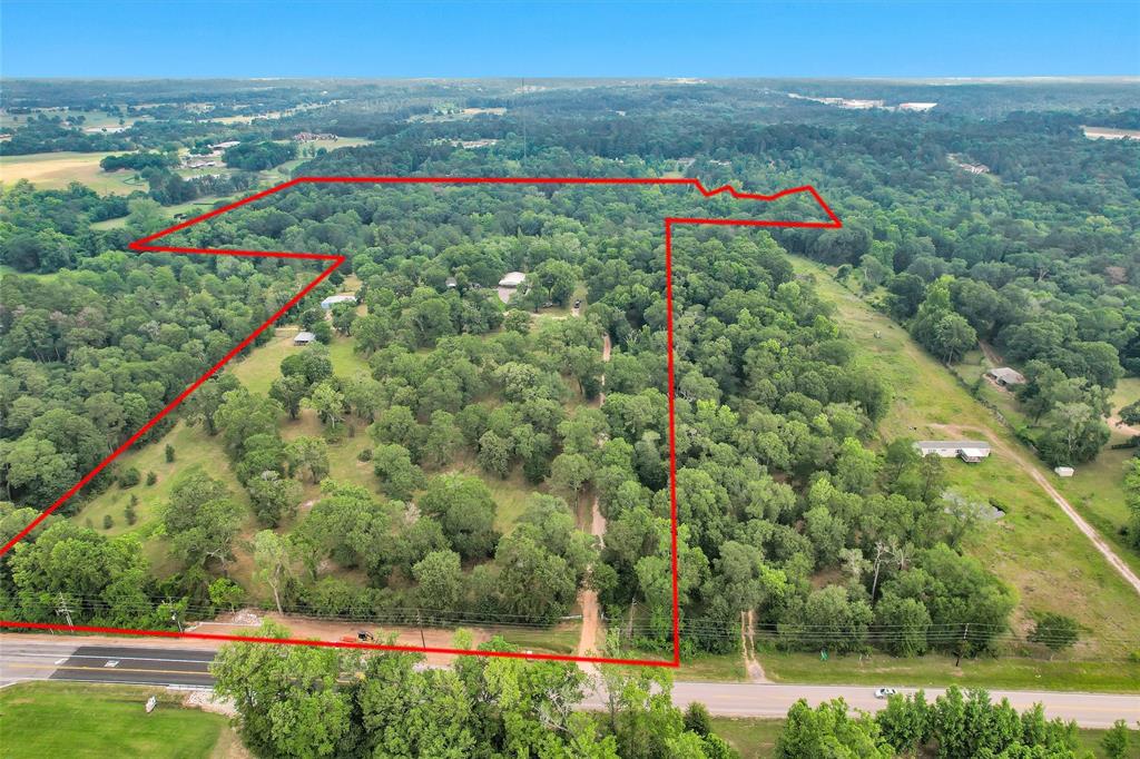 A little over 30 acres of improved pastures less than 1 mile from I-45 in Willis, TX.  A well taken care of 4-bedroom 2 bath mobile home sits atop the hill with views from the front and back of the house.  Nice living area, open kitchen to the dining and breakfast area.  The master bedroom is oversized with a nice sitting area or office, 3 spare bedrooms occupy the other end of the house. Property has a 40x46 metal shop with a 20x40 carport on the front and a 24x24 lean to off the side, half of the shop is built out and climate controlled with a bedroom and full bath built.  There are two other buildings on the property, a 5-stall horse barn that is 36x40 with a 20x40 lean to and an open storage building that is 18x35, with a loafing shed that is 20x30.  Scattered hardwood trees, fenced and cross fenced this property has a lot to offer, whether looking for a horse farm, a place to run some cattle, a family compound with plenty of places for everyone to build or a new development!!